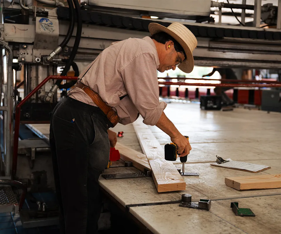 A man assembling a truss