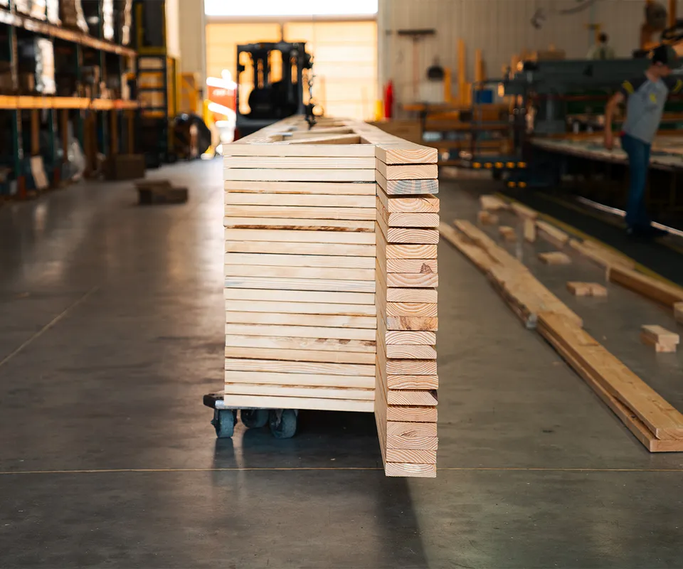 A view from the end of a tall stack of trusses
